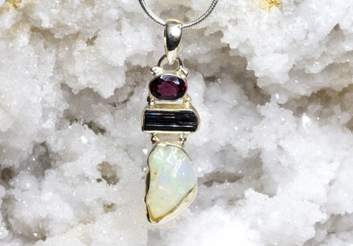 Welo Opal 8.44 ct with tourmaline and garnet set in silver